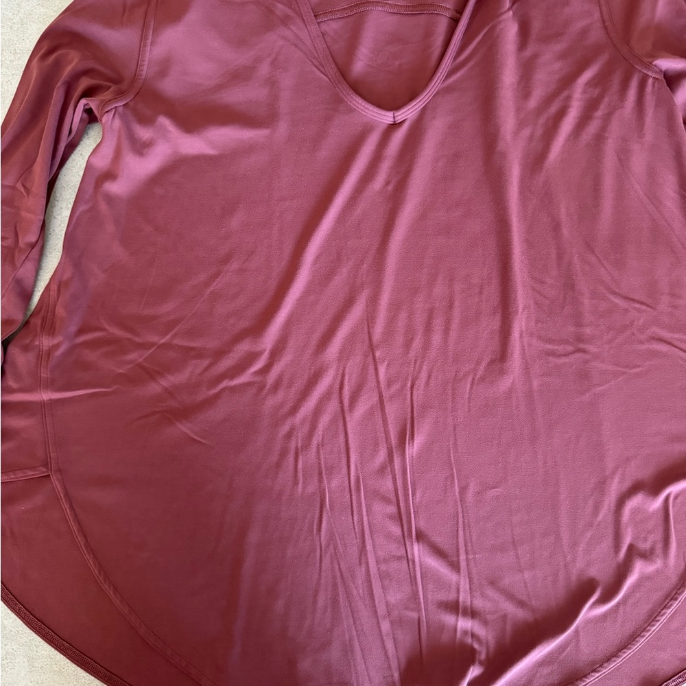 Lululemon maroon. long sleeves. Logo in back. V neck Bell shape arms and body.